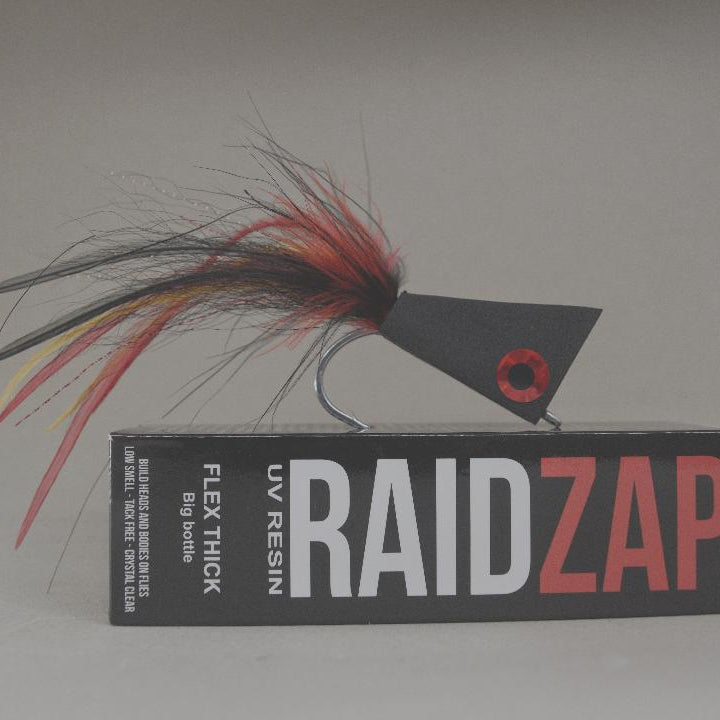 Fishing lure with 'RAIDZAP' packaging on a gray background